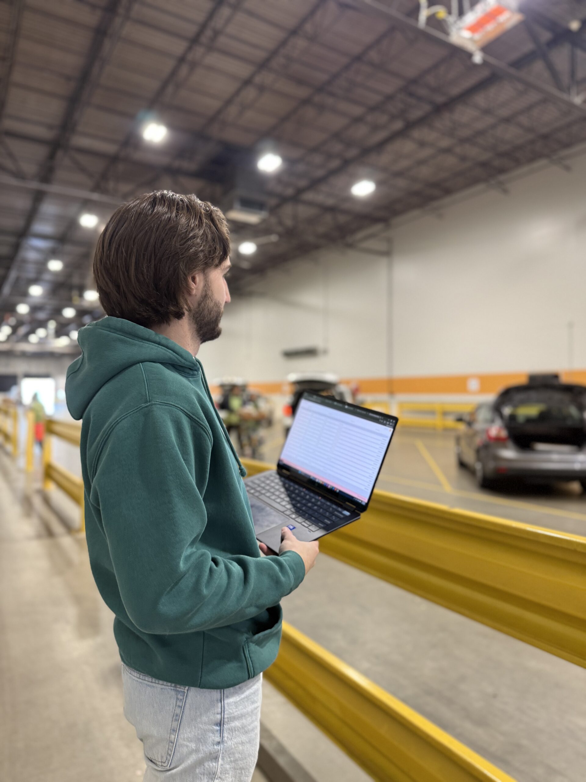 Counterpart team members observe the Groceries2Go platform in use at a Gleaners drive-thru distribution