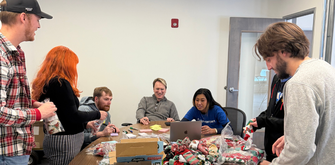 Steve, Loren, Ian, Drew, Arianna, Jade, and JT put together Believe Bags